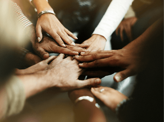 hands of diversed people placed together